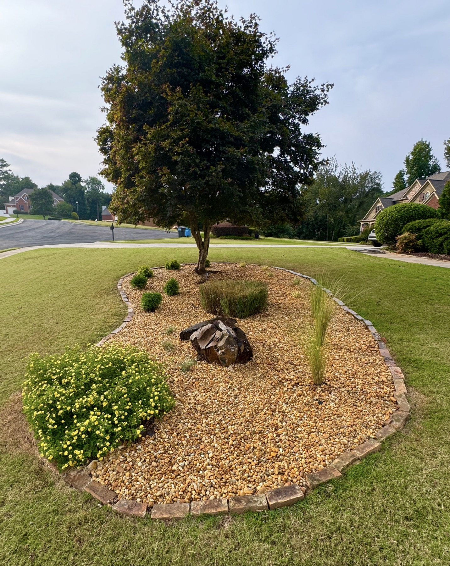 Landscape lighting highlighting sculpted shrubs and colorful flower bed in Sandy Springs, GA